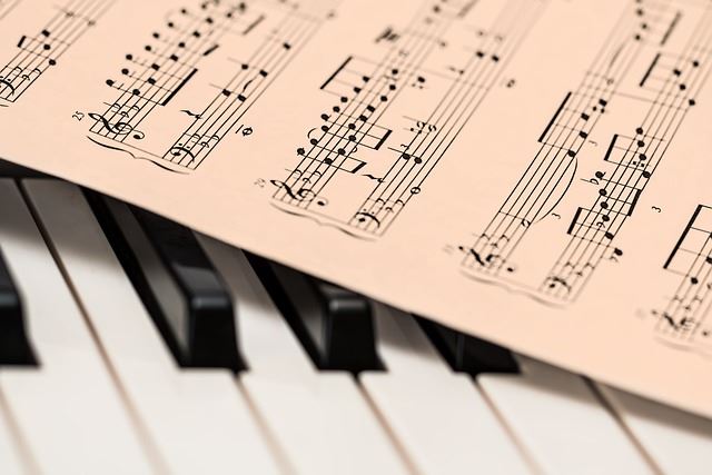 piano keyboard and a sheet of music